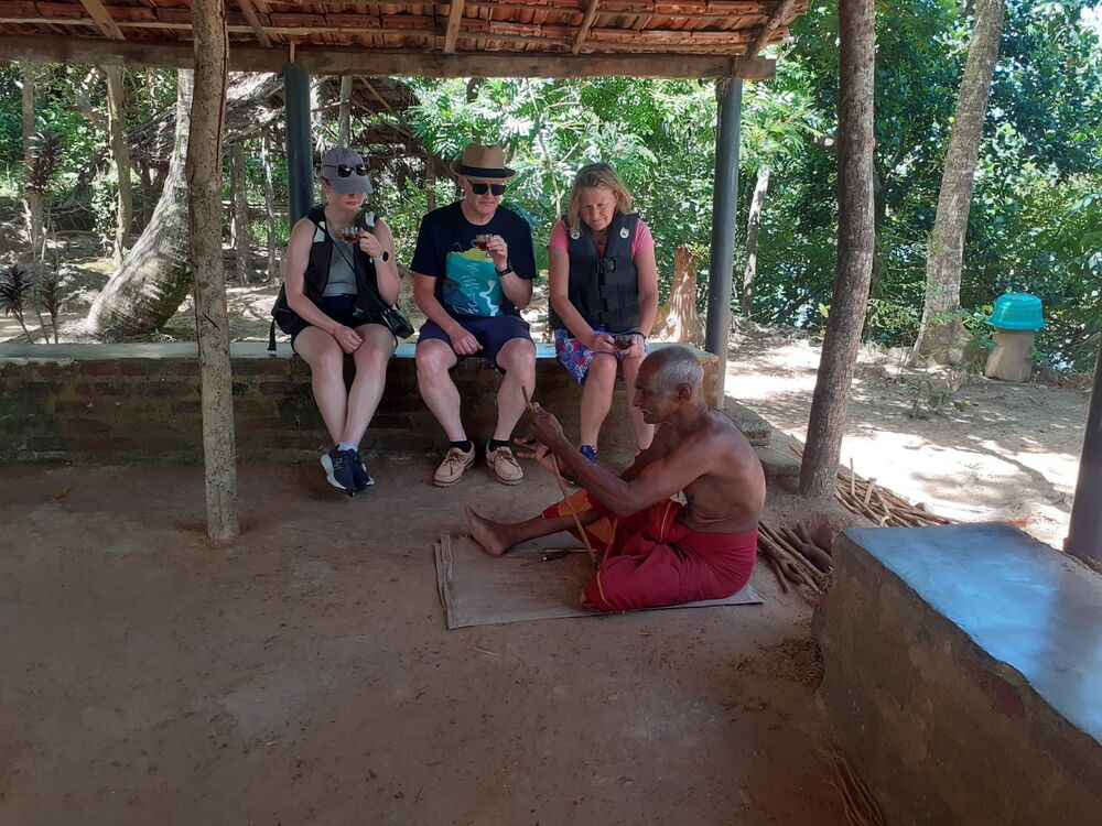 Local craftsman demonstrating traditional work to guests on a riverside stop