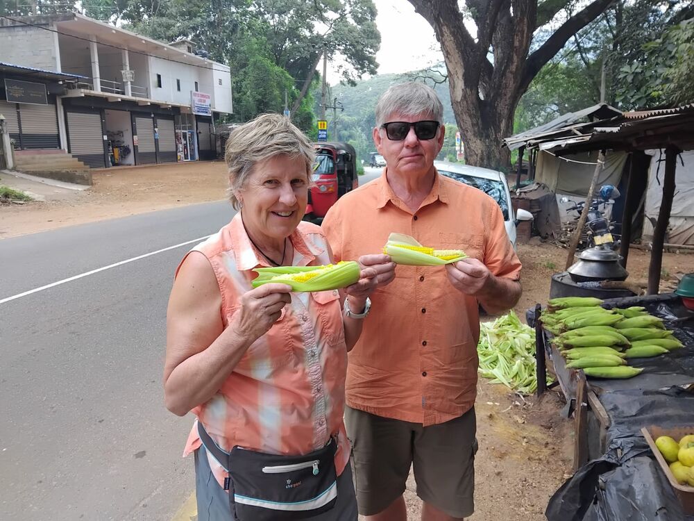 Guests sharing roasted corn from a roadside stall in Sri Lanka