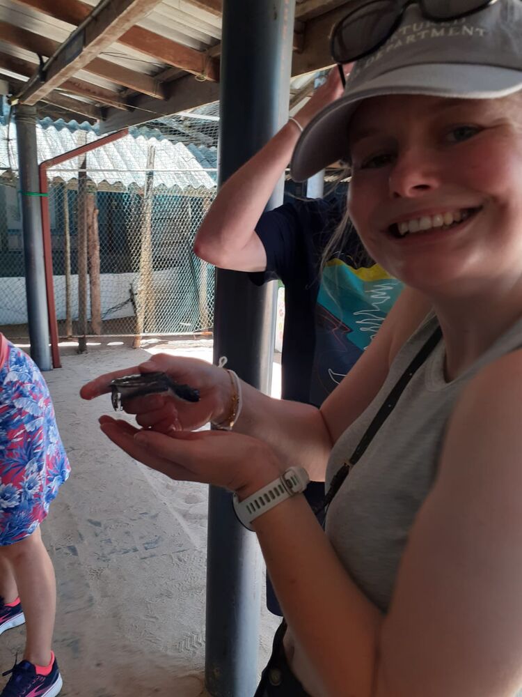 Guest holding a turtle hatchling, Sri Lanka south coast