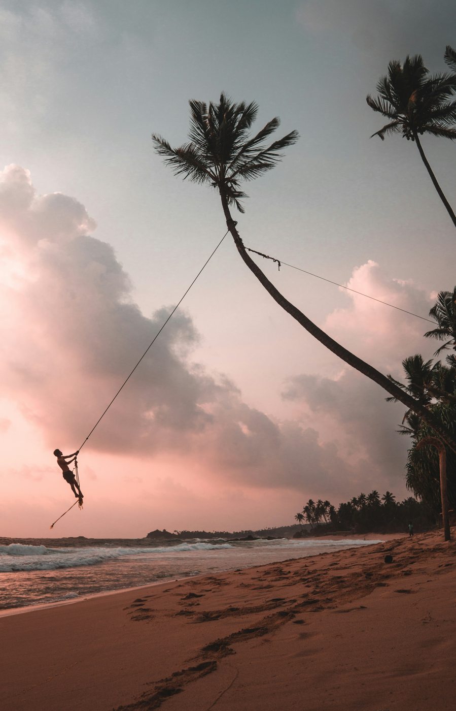 Rope swing over the ocean at sunset, Sri Lanka south coast